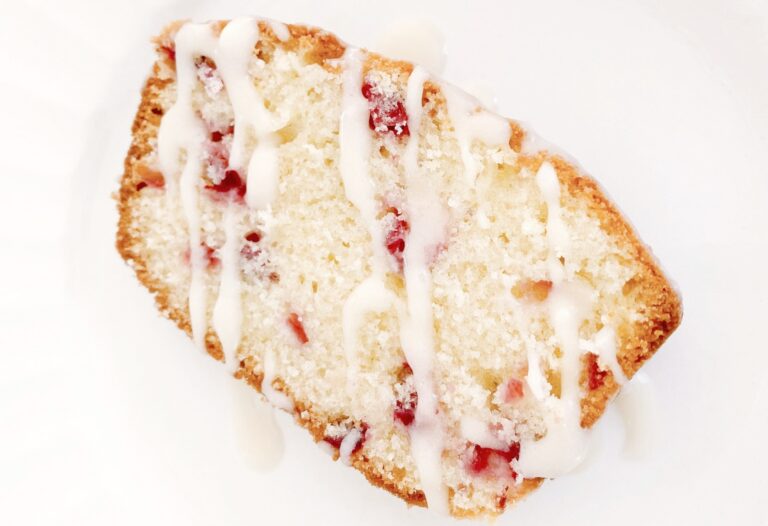 Slice of lemon cranberry loaf with glaze icing