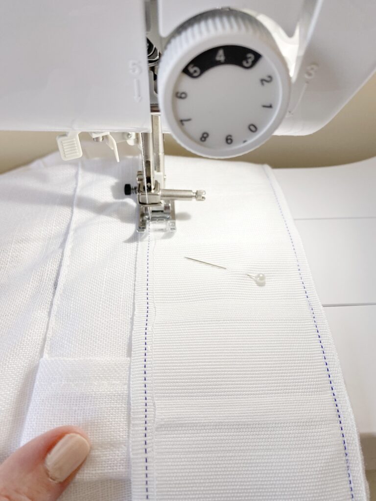 sewing the pinch pleat tape to the curtain.